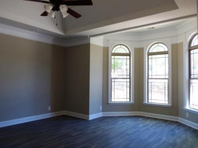 211 Timber Ridge Boulevard Byron, GA 31008 - Photo 16 of 31 a view of empty room with wooden floor and fan