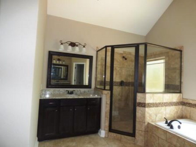 211 Timber Ridge Boulevard Byron, GA 31008 - Photo 20 of 31 a bathroom with a granite countertop sink and a mirror