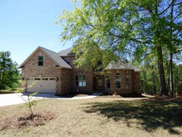 211 Timber Ridge Boulevard Byron, GA 31008 - Photo 3 of 31 a front view of a house with a yard and garage