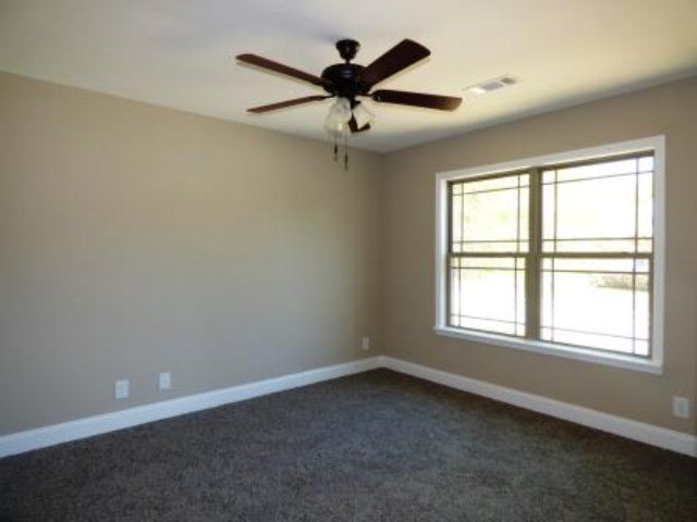 211 Timber Ridge Boulevard Byron, GA 31008 - Photo 24 of 31 an empty room with a window and a fan