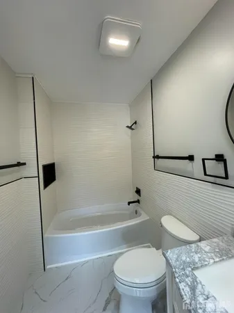 a bathroom with a toilet a sink and bathtub