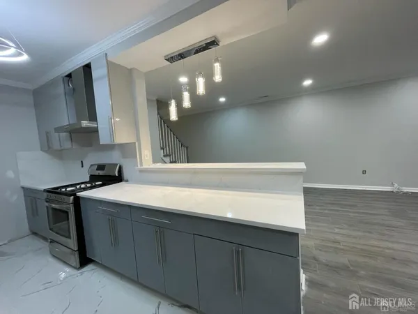 a kitchen with stainless steel appliances a sink stove and cabinets