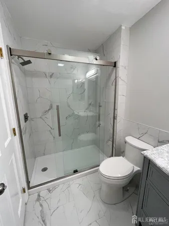 a bathroom with a toilet and shower