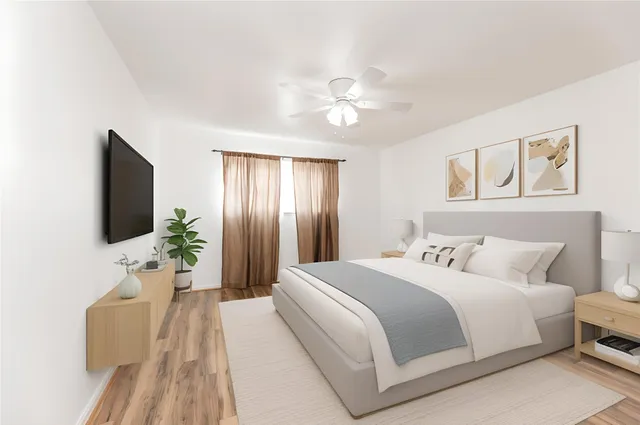 a bedroom with a large bed and a flat screen tv