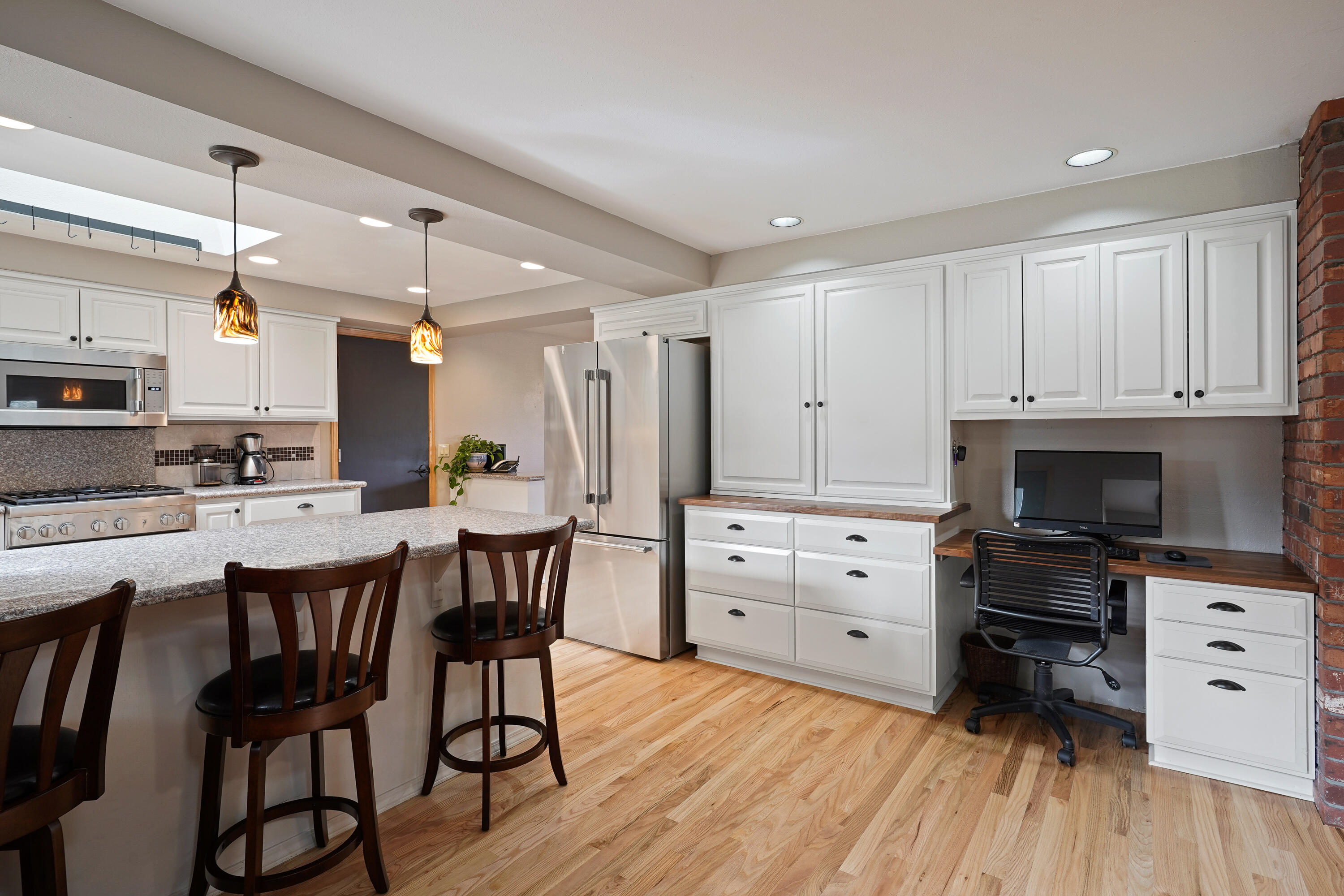 70030 Meadow View Road Sisters, OR 97759 - Photo 11 of 43 a kitchen with white cabinets and stainless steel appliances