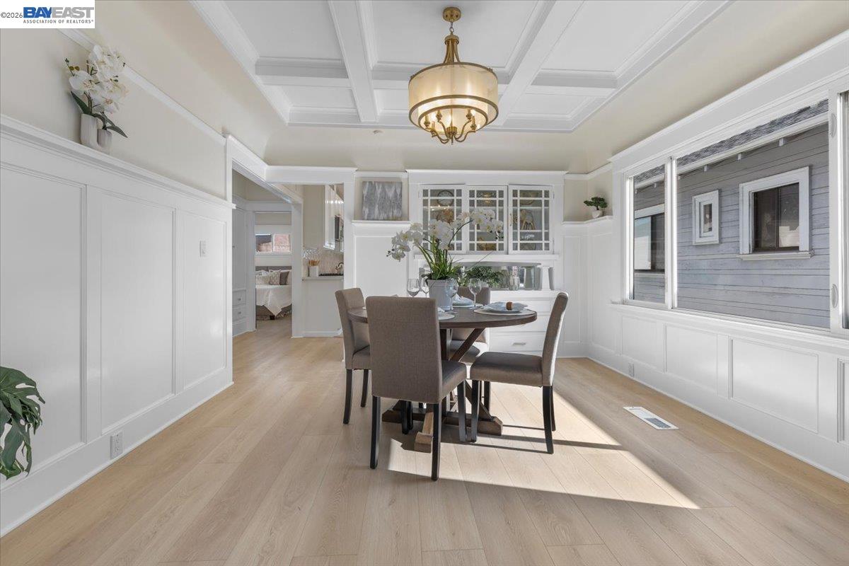 1237 Ashby Avenue Berkeley, CA 94702 - Photo 12 of 31 a dining room with furniture a chandelier and wooden floor