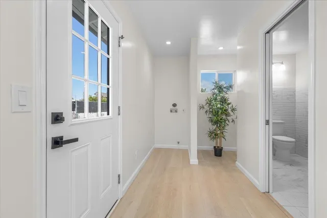 a view of a hallway with potted plants