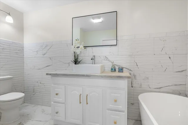 a bathroom with a sink a toilet and mirror