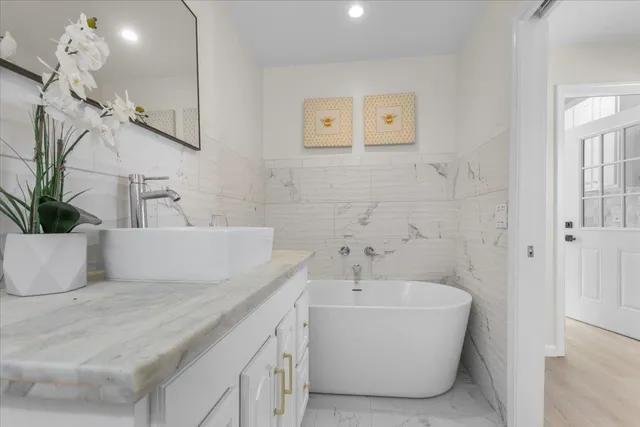 a bathroom with a bathtub and shower