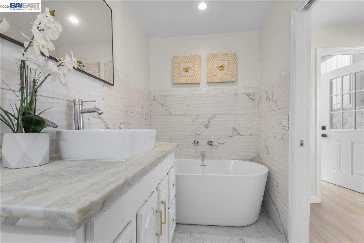 1237 Ashby Avenue Berkeley, CA 94702 - Photo 22 of 31 a bathroom with a bathtub and a sink
