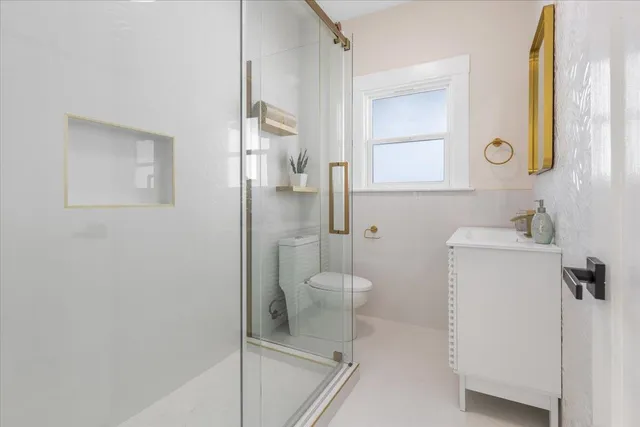 a bathroom with a toilet sink and a mirror