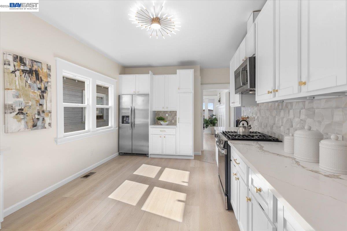 1237 Ashby Avenue Berkeley, CA 94702 - Photo 7 of 31 a kitchen with stainless steel appliances a stove a sink and a refrigerator