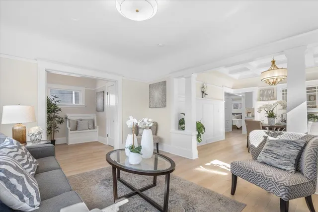 a living room with furniture and wooden floor