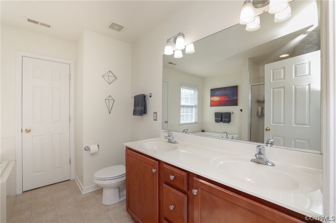 1600 Winterfield Place Midlothian, VA 23113 - Photo 33 of 43 a bathroom with a sink a toilet and a large mirror