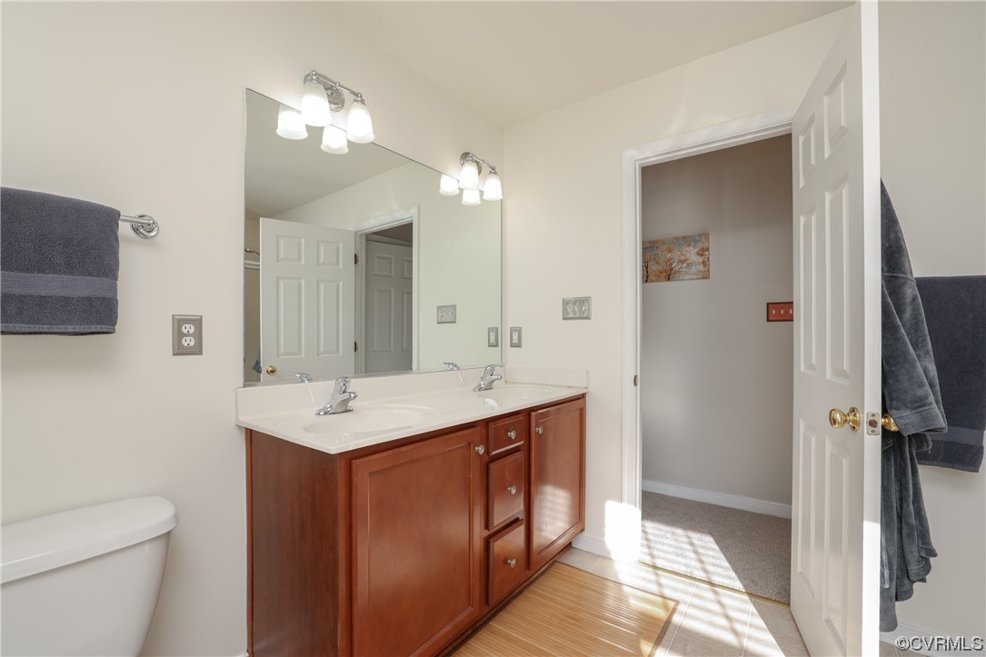1600 Winterfield Place Midlothian, VA 23113 - Photo 34 of 43 a bathroom with a sink a toilet a mirror and vanity