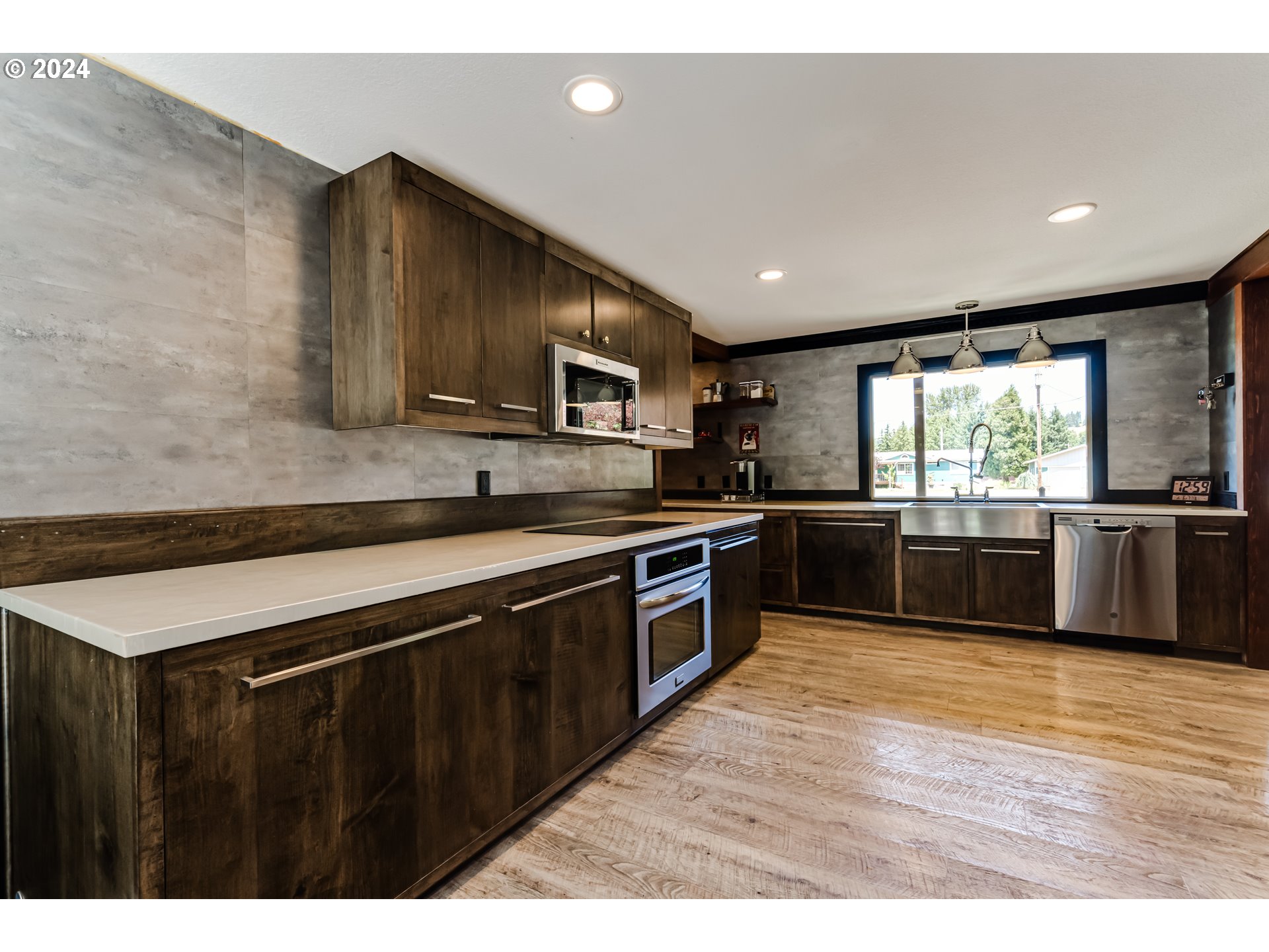 37198 Wheeler Road Pleasant Hill, OR 97455 - Photo 19 of 46 a kitchen with stainless steel appliances kitchen island granite countertop a stove a sink and a microwave