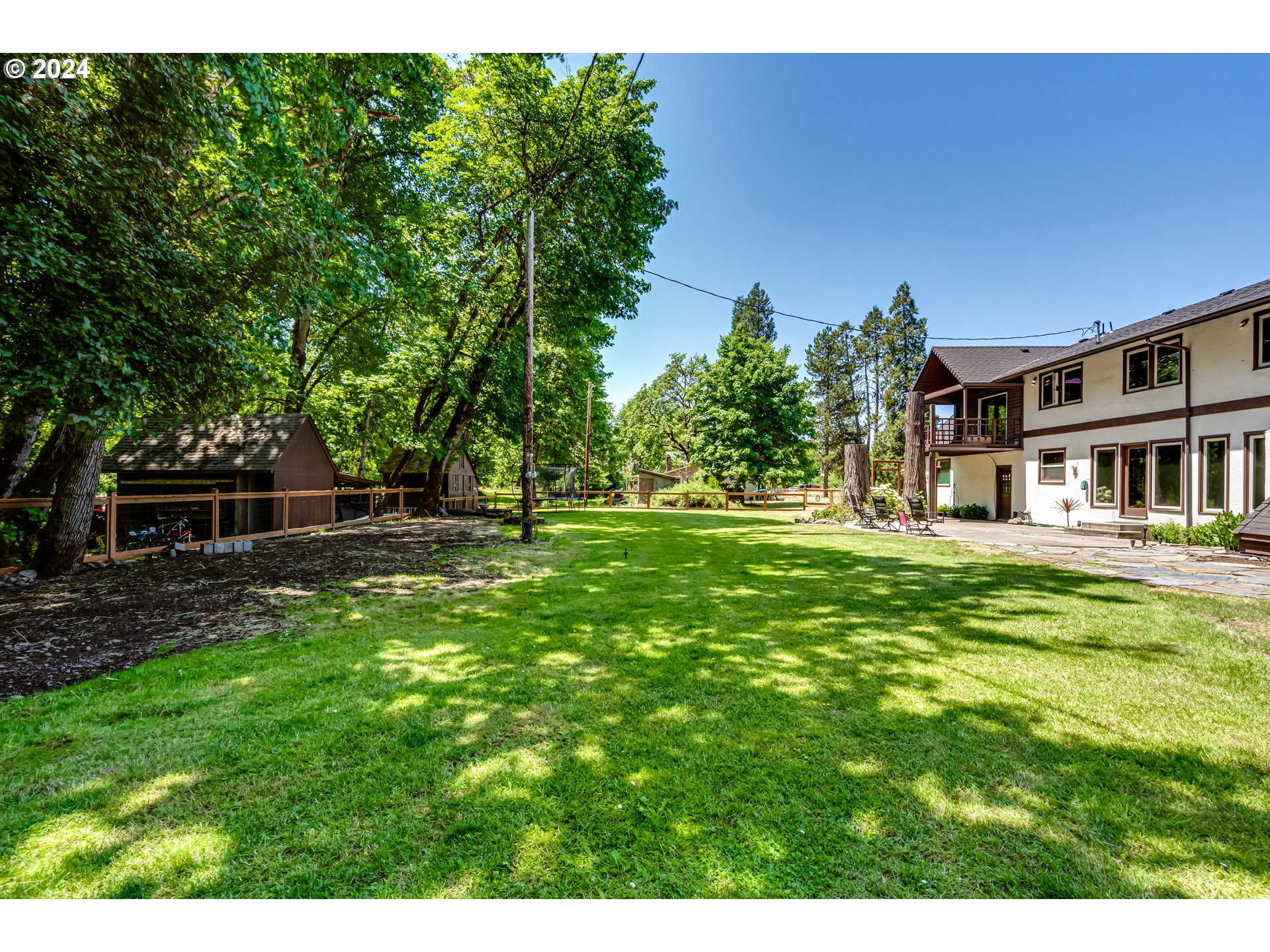 37198 Wheeler Road Pleasant Hill, OR 97455 - Photo 43 of 46 a backyard of a house with lots of green space and fountain