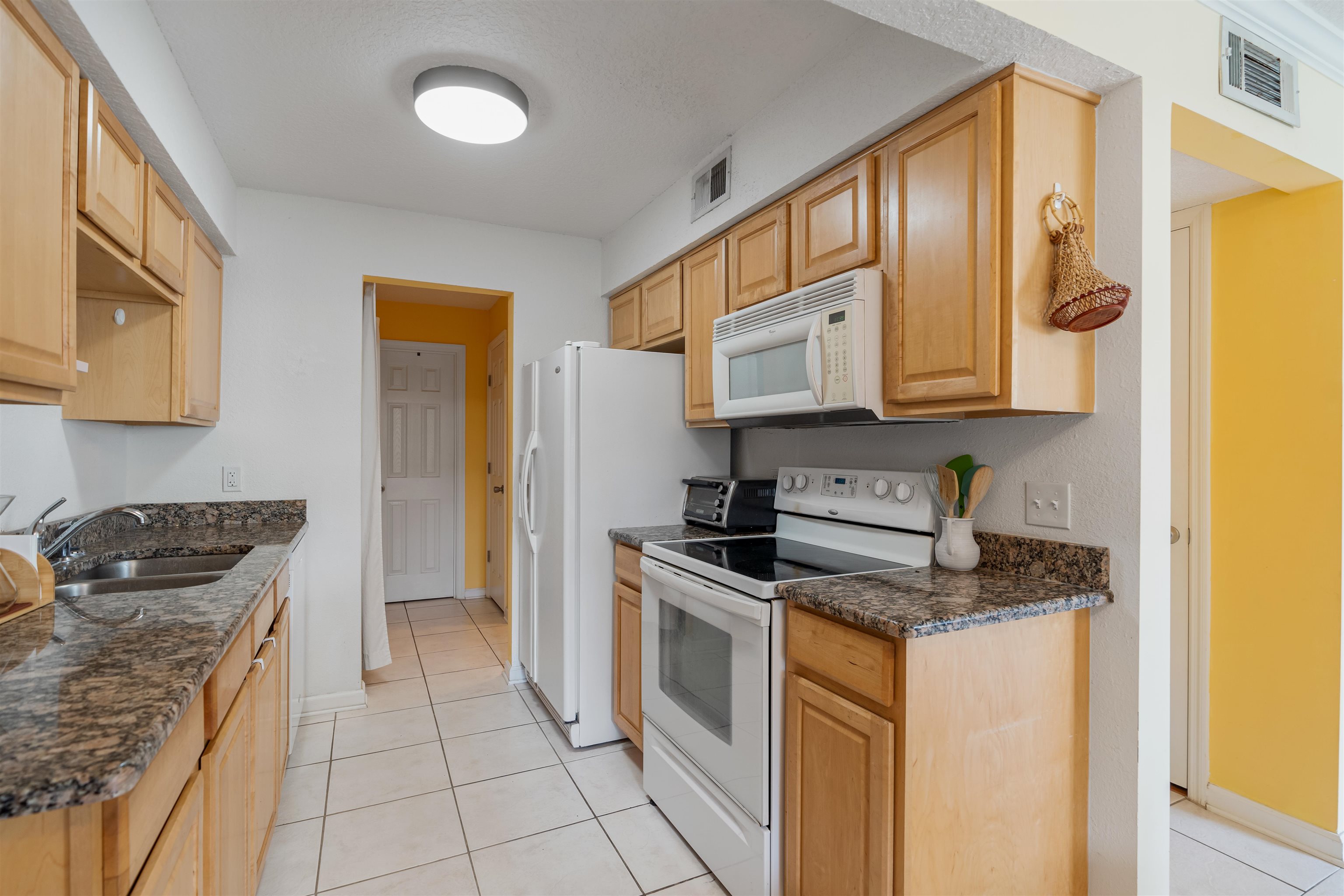 10 Brigantine Court St. Augustine, FL 32080 - Photo 9 of 26 a kitchen with stainless steel appliances granite countertop a stove a sink and a refrigerator