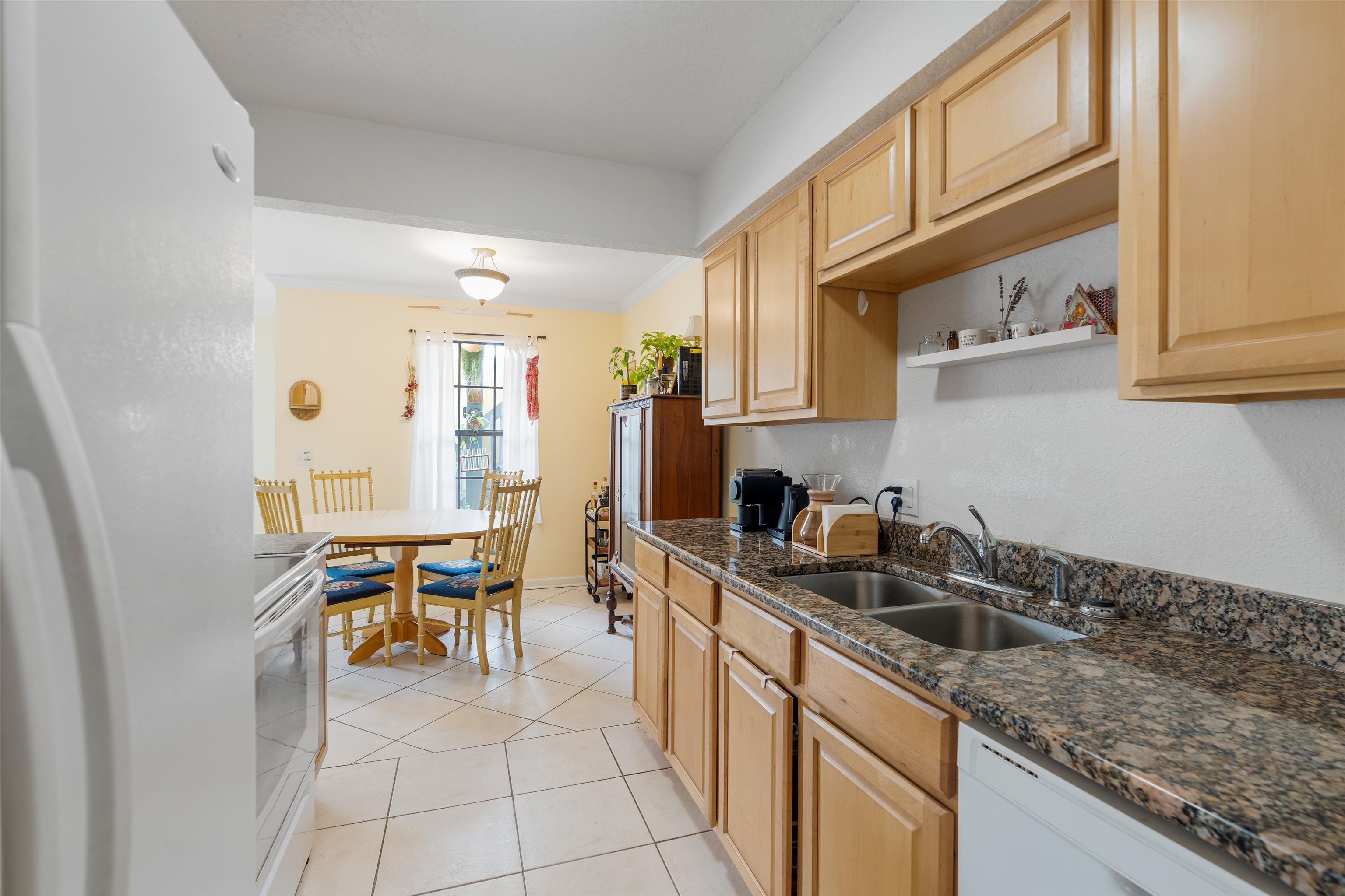 10 Brigantine Court St. Augustine, FL 32080 - Photo 10 of 26 a kitchen that has a sink and chairs