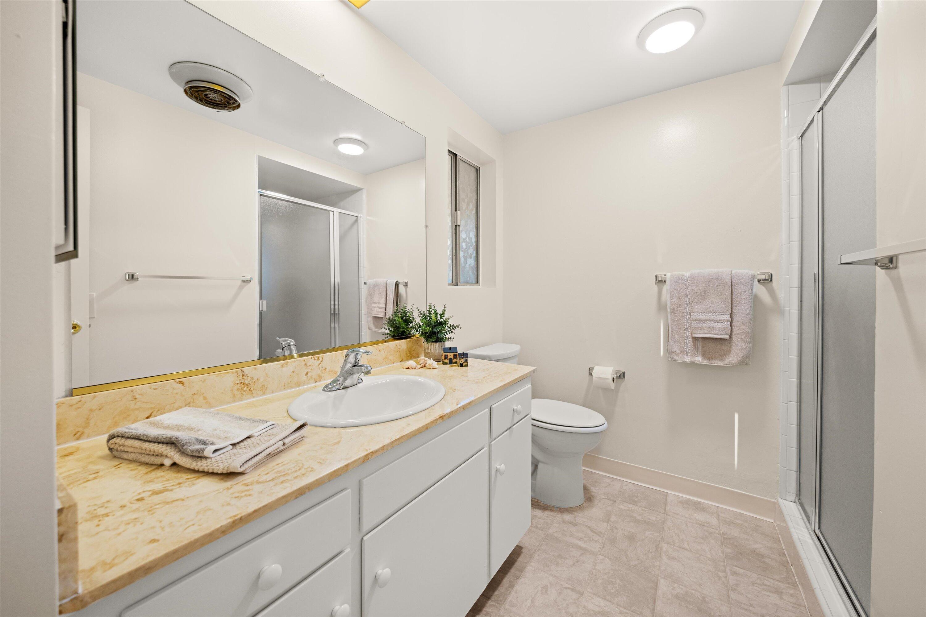 5722 Encina Road, Unit 4 Goleta, CA 93117 - Photo 12 of 28 a bathroom with a granite countertop sink and a mirror