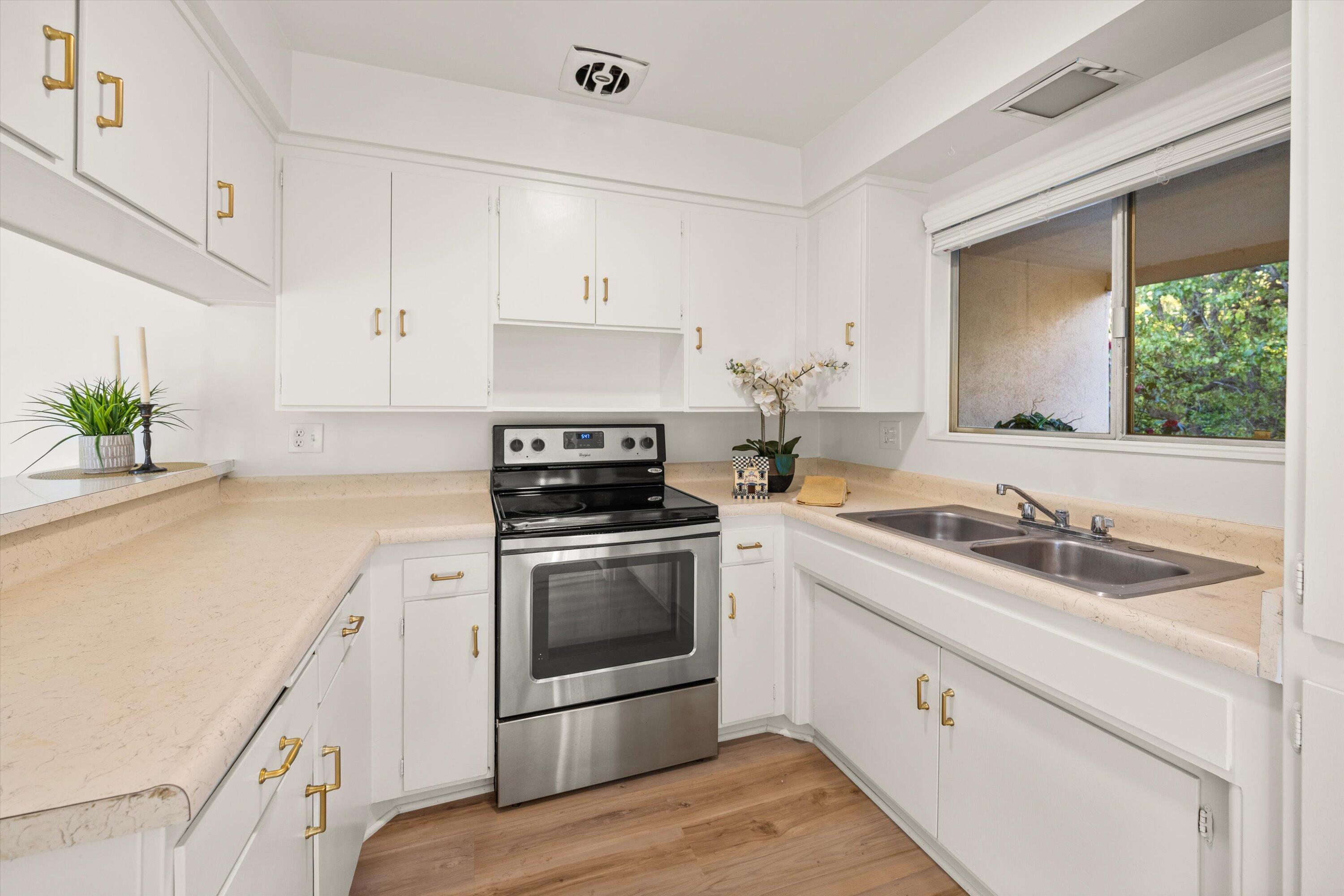 5722 Encina Road, Unit 4 Goleta, CA 93117 - Photo 9 of 28 a kitchen with granite countertop white cabinets and white appliances