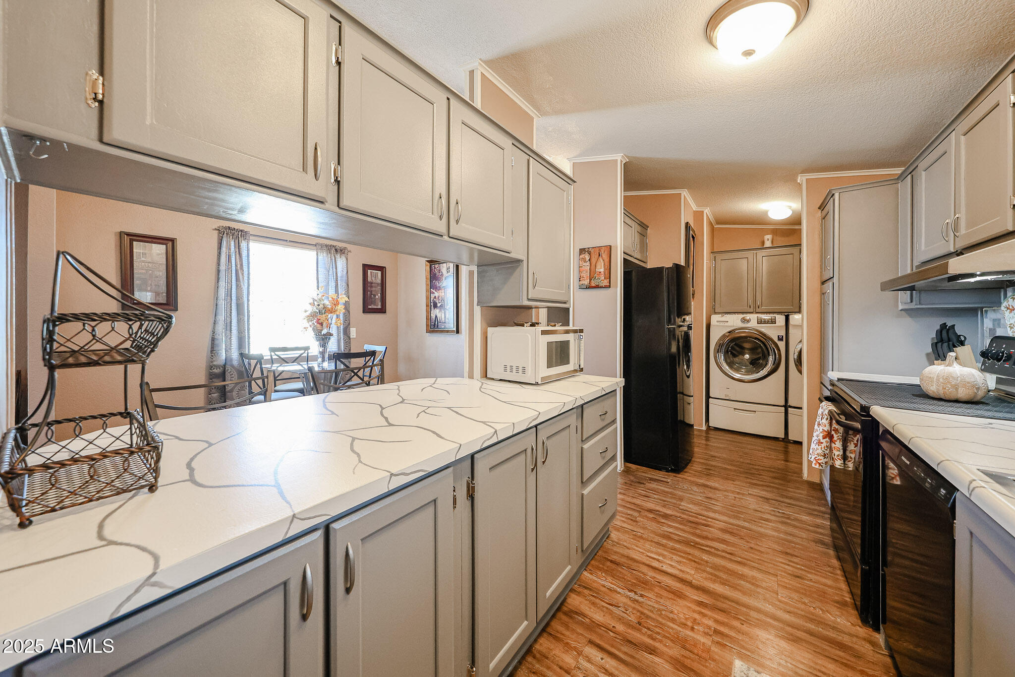 19602 North 32nd Street, Unit 32 Phoenix, AZ 85050 - Photo 18 of 37 a kitchen with stainless steel appliances granite countertop a sink and cabinets