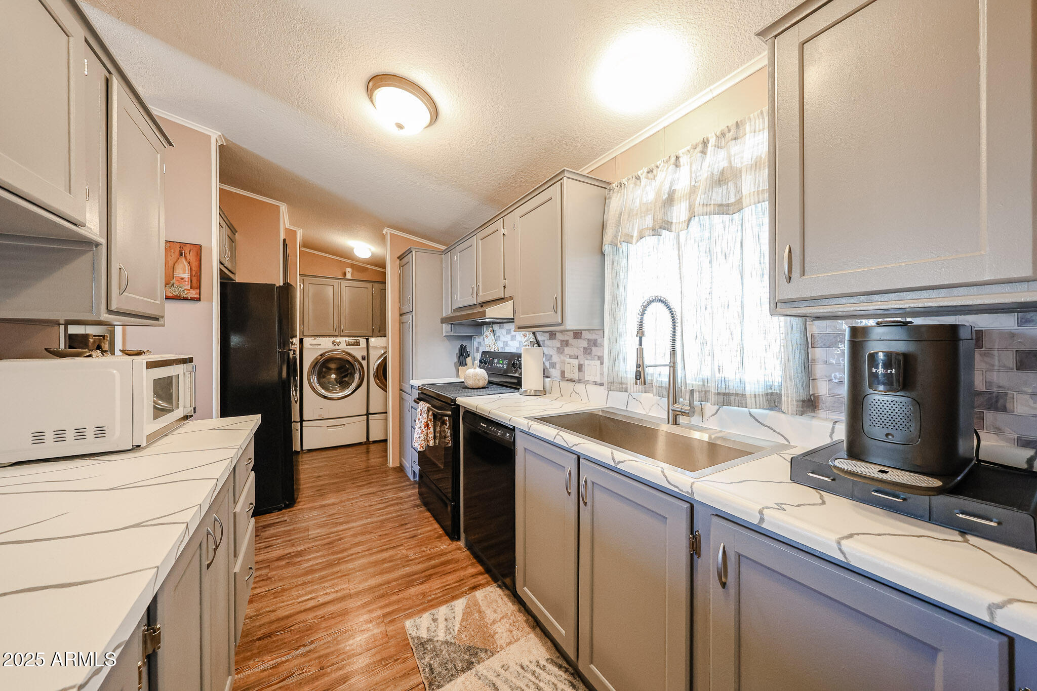 19602 North 32nd Street, Unit 32 Phoenix, AZ 85050 - Photo 19 of 37 a kitchen with a sink stove and refrigerator