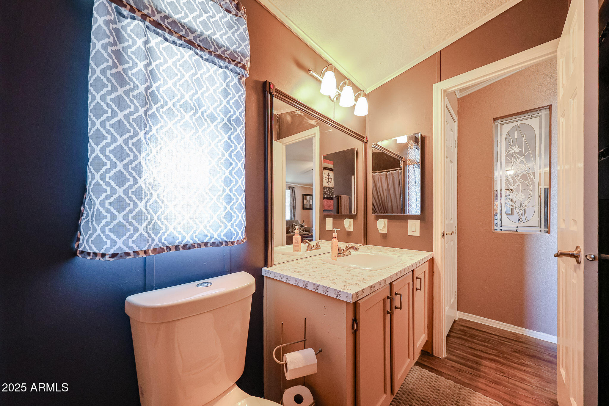 19602 North 32nd Street, Unit 32 Phoenix, AZ 85050 - Photo 28 of 37 a bathroom with a sink and mirror with toilet