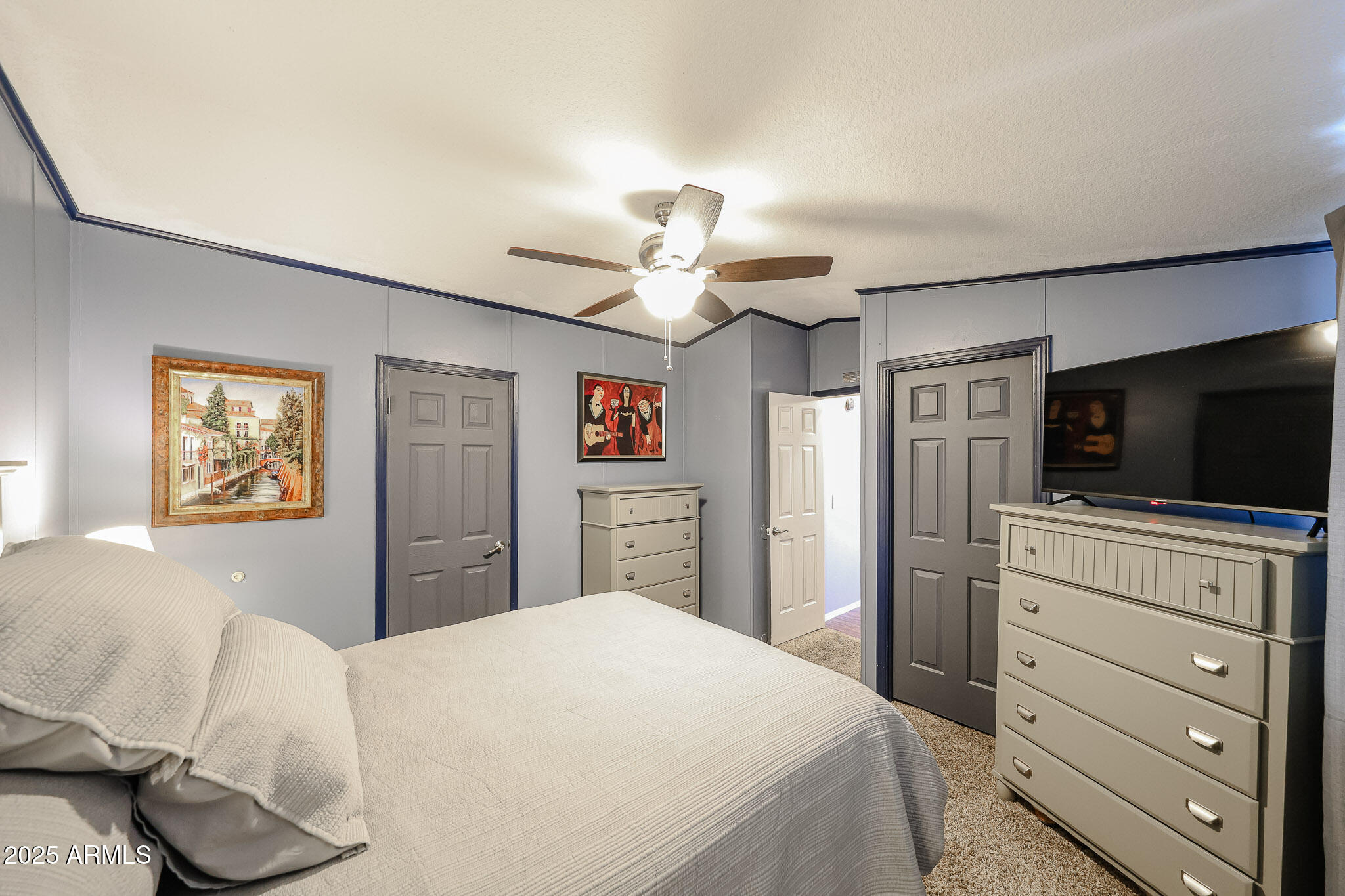 19602 North 32nd Street, Unit 32 Phoenix, AZ 85050 - Photo 30 of 37 a bedroom with a bed and a flat screen tv
