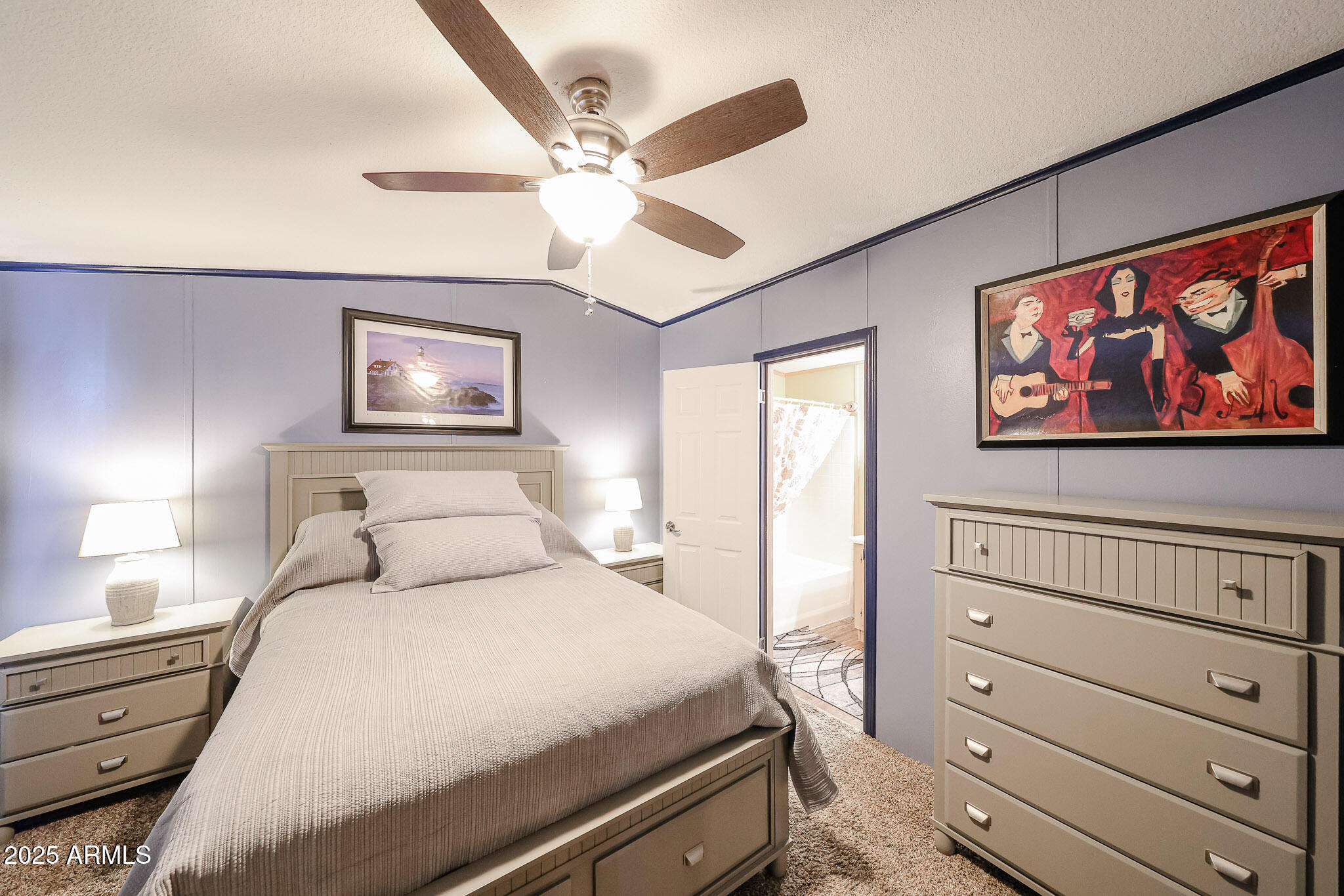 19602 North 32nd Street, Unit 32 Phoenix, AZ 85050 - Photo 31 of 37 a bedroom with a bed and a painting on the wall