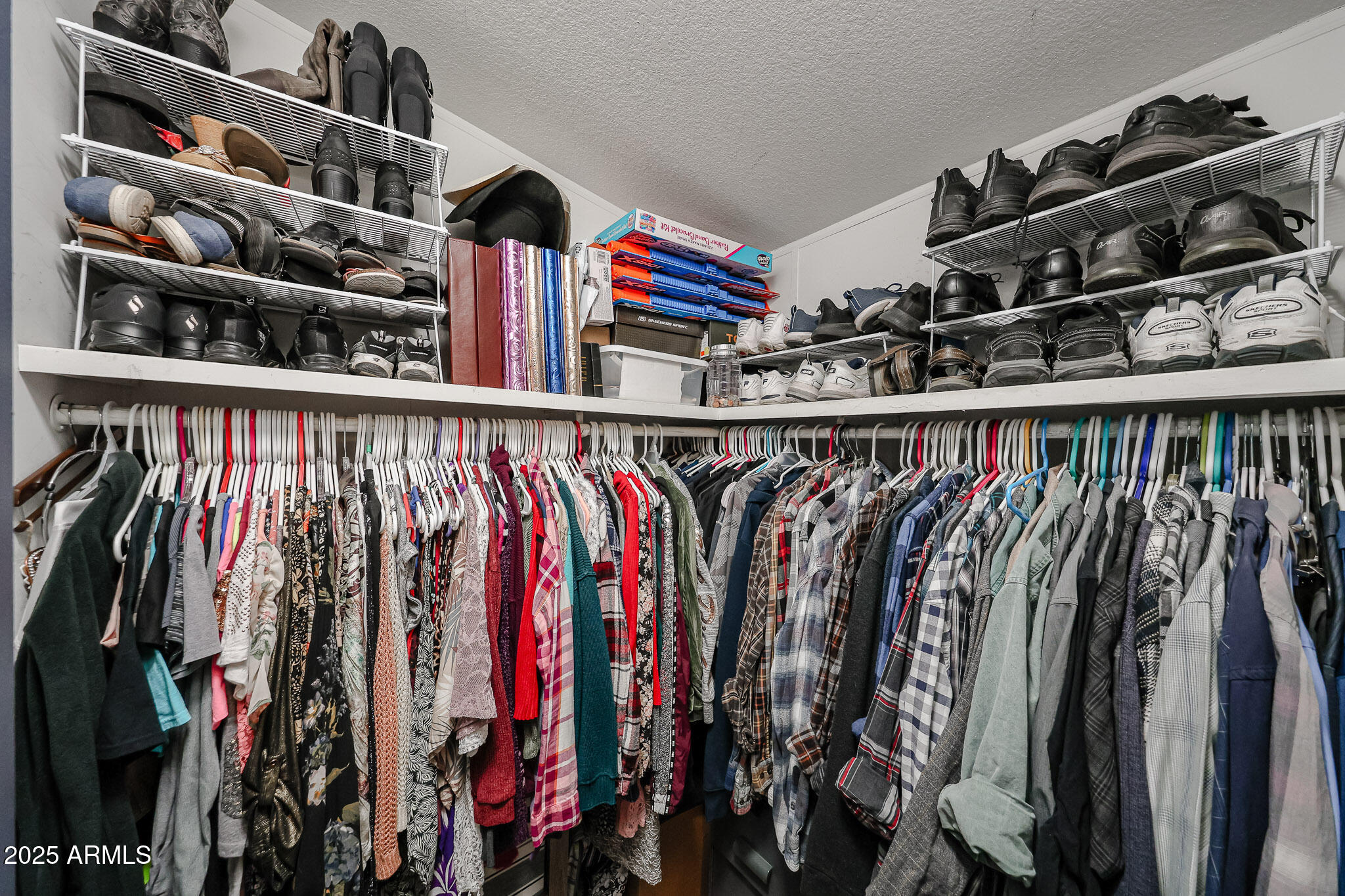 19602 North 32nd Street, Unit 32 Phoenix, AZ 85050 - Photo 32 of 37 a view of walk in closet with clothes and shoes