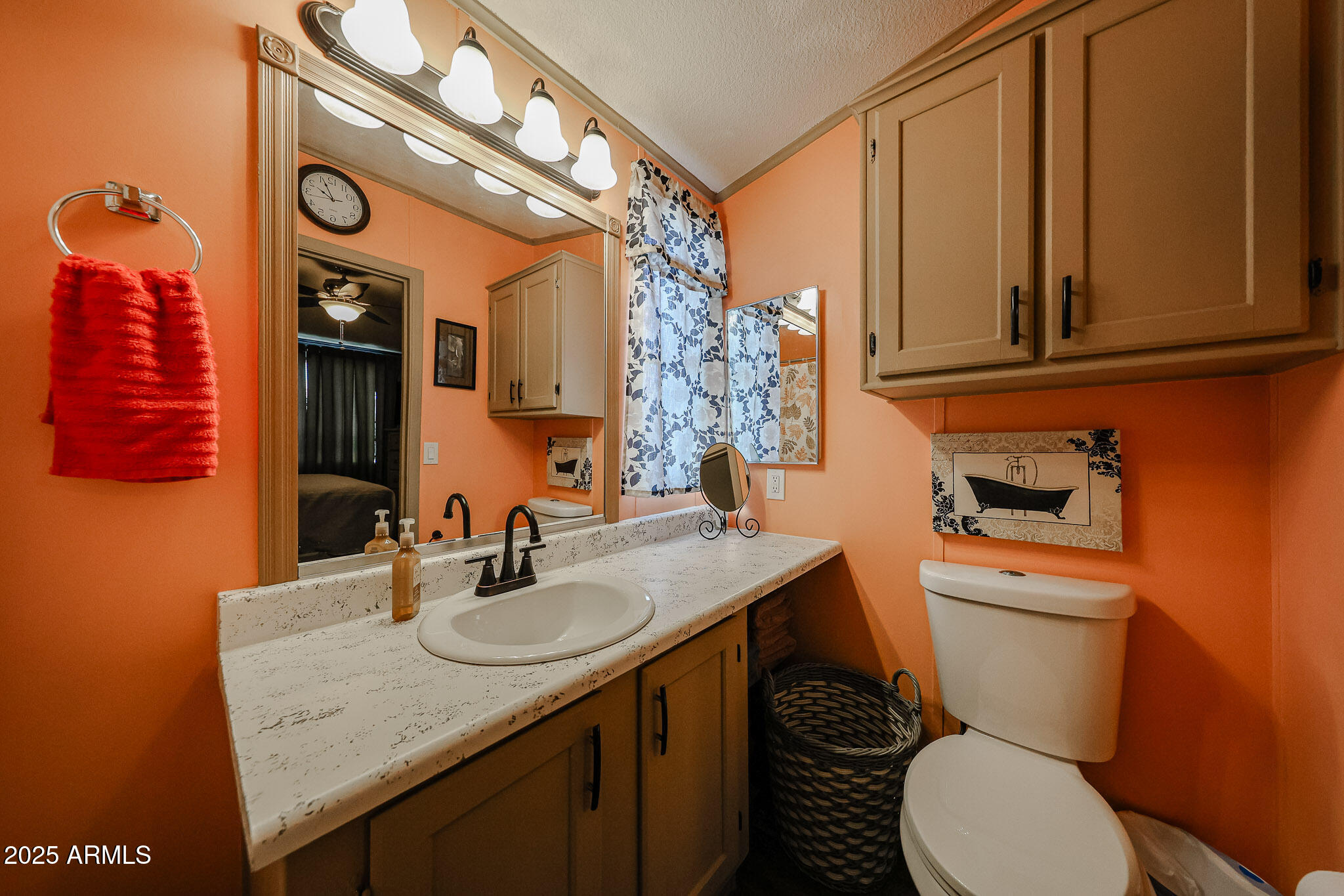 19602 North 32nd Street, Unit 32 Phoenix, AZ 85050 - Photo 33 of 37 a bathroom with a granite countertop toilet sink and mirror