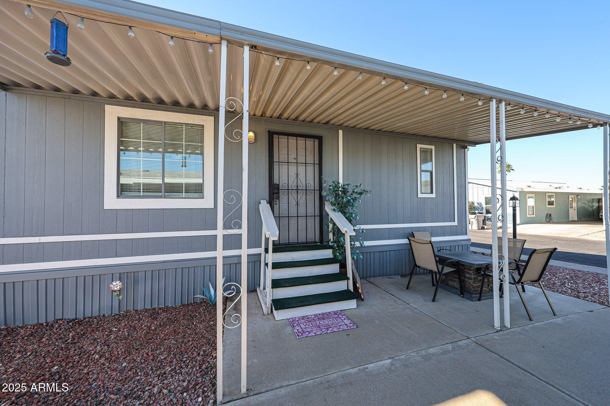 19602 North 32nd Street, Unit 32 Phoenix, AZ 85050 - Photo 4 of 37 a view of a patio with table and chairs with wooden floor and fence