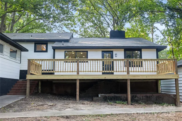a view of a house with a yard and sitting area