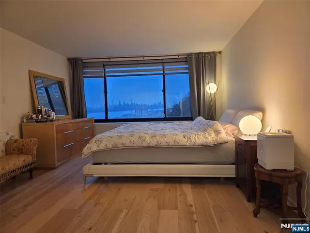 a bedroom with a bed window and dresser