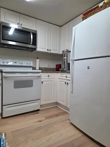 a kitchen with a sink cabinets and stainless steel appliances