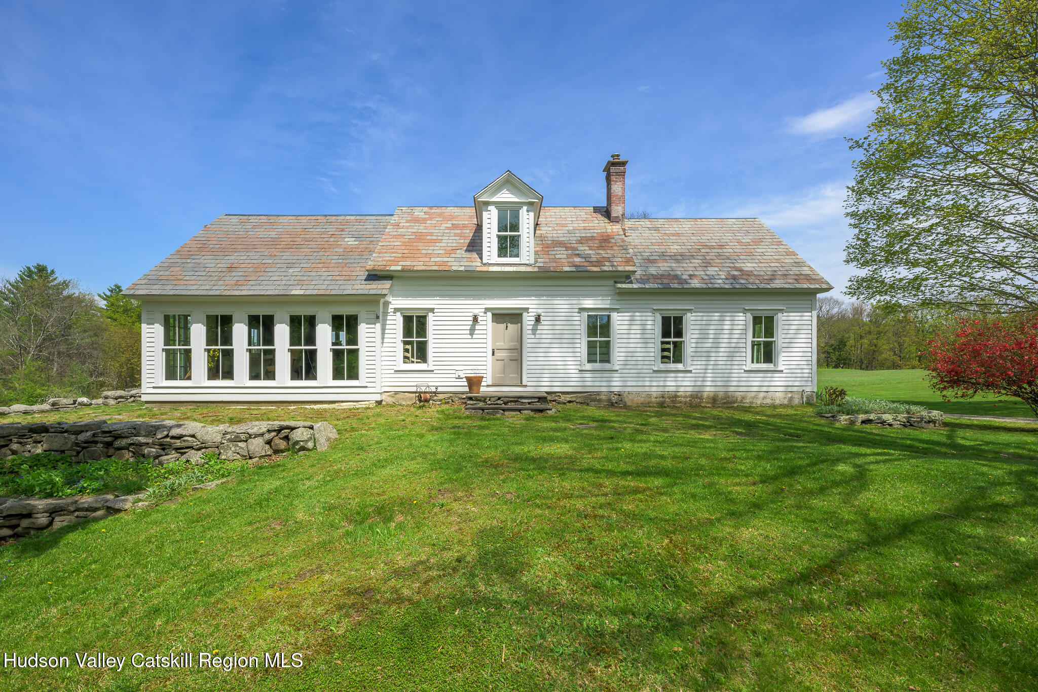 159 Riders Mills Road Old Chatham, NY 12136 - Photo 1 of 42 a front view of a house with a garden