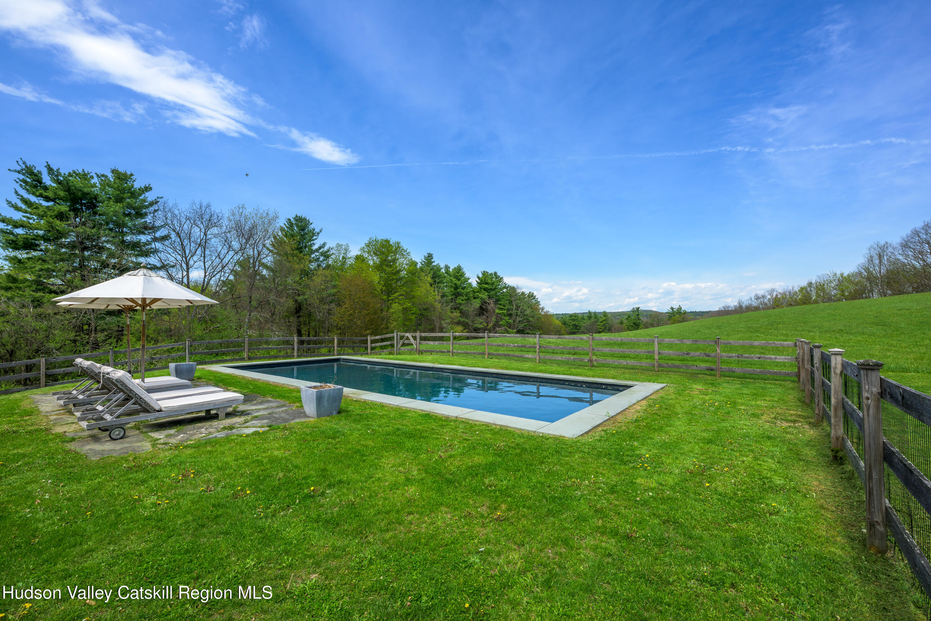 159 Riders Mills Road Old Chatham, NY 12136 - Photo 6 of 42 a view of a garden with lawn chairs under an umbrella