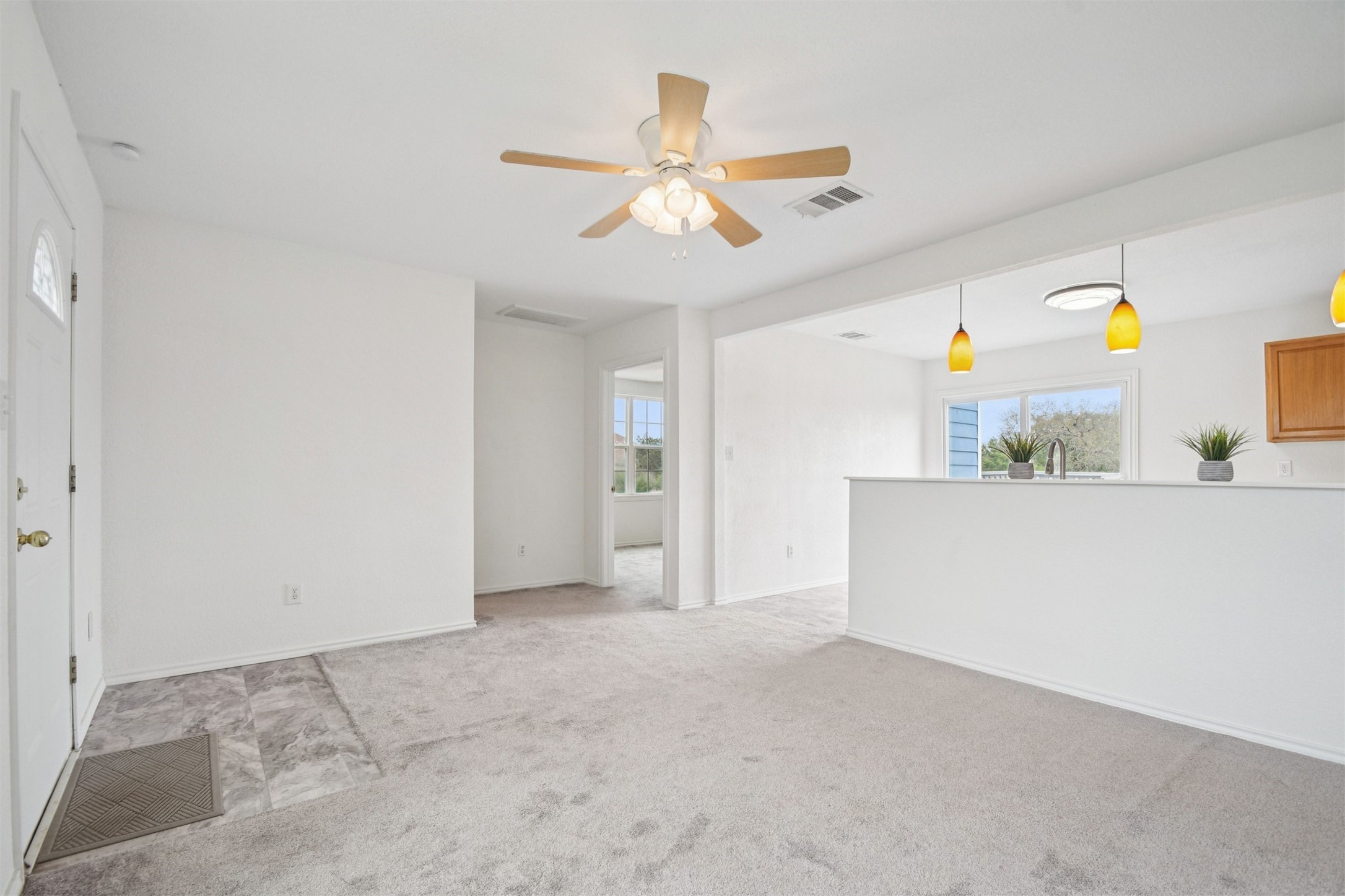 1470 Oak Grove Road Leander, TX 78641 - Photo 6 of 38 a view of a kitchen with a stove and a ceiling fan