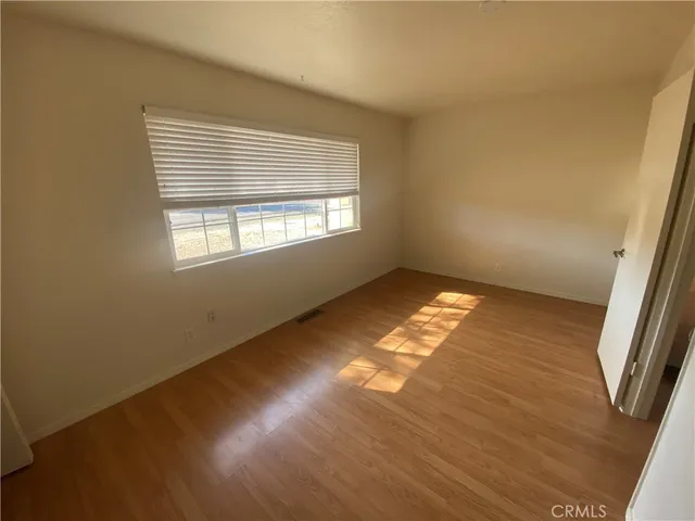 a bathroom with a granite countertop sink mirror vanity and toilet
