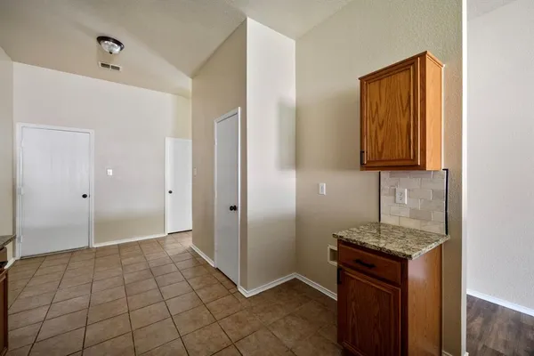 a view of kitchen with cabinets and wooden floor