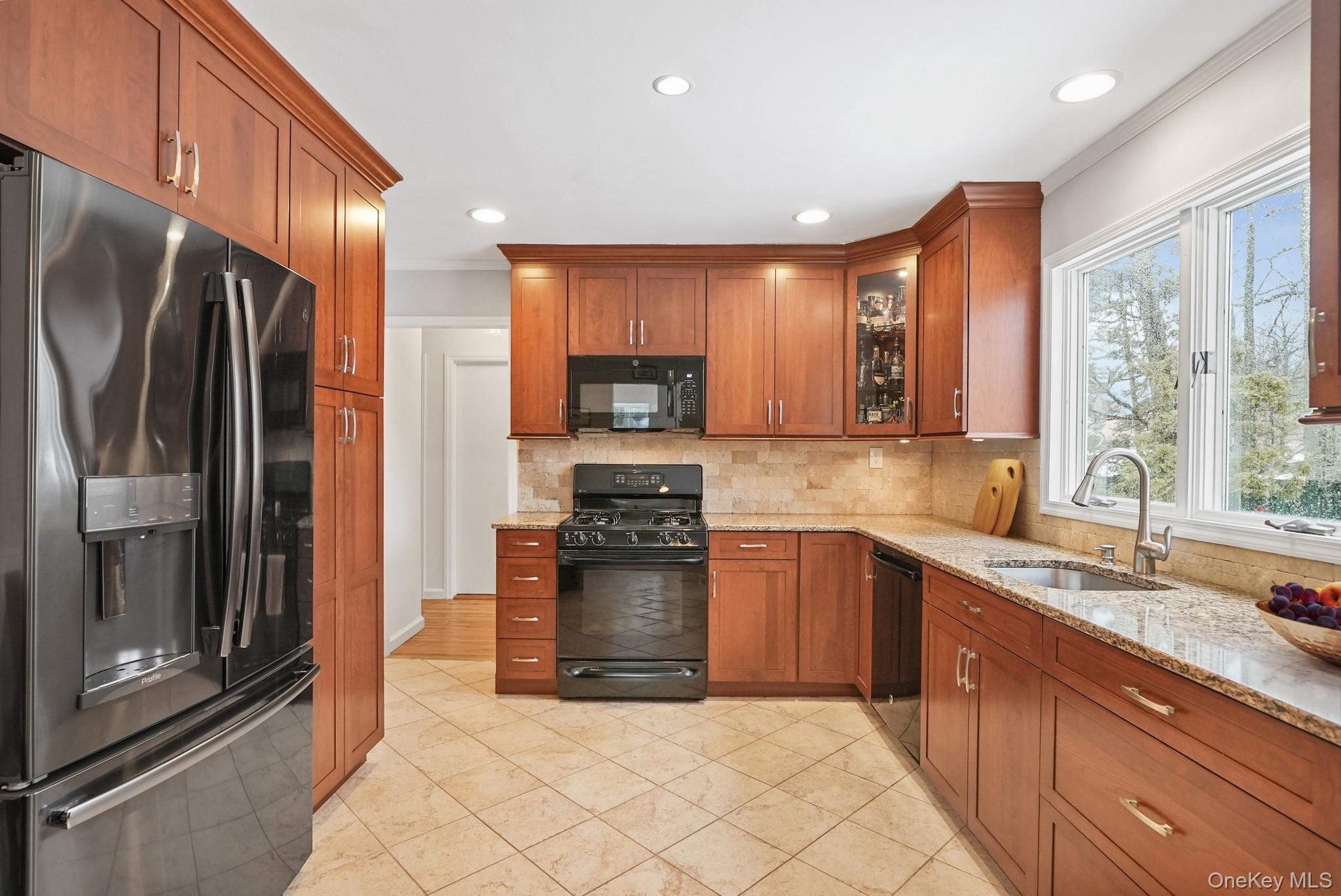 33 Overlook Road Ardsley, NY 10502 - Photo 11 of 32 a kitchen with stainless steel appliances granite countertop a refrigerator a sink a stove with cabinets and wooden floor