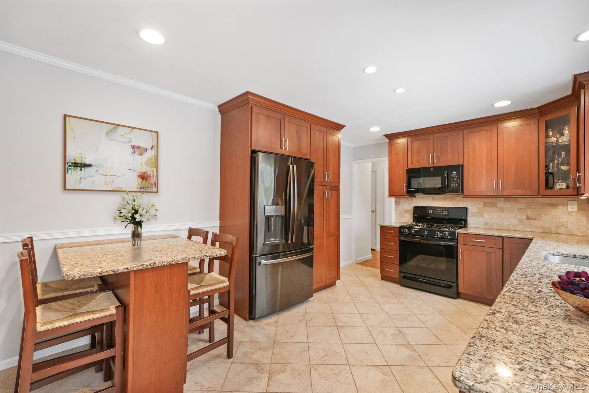 33 Overlook Road Ardsley, NY 10502 - Photo 12 of 32 a kitchen with stainless steel appliances kitchen island granite countertop a refrigerator and a stove top oven