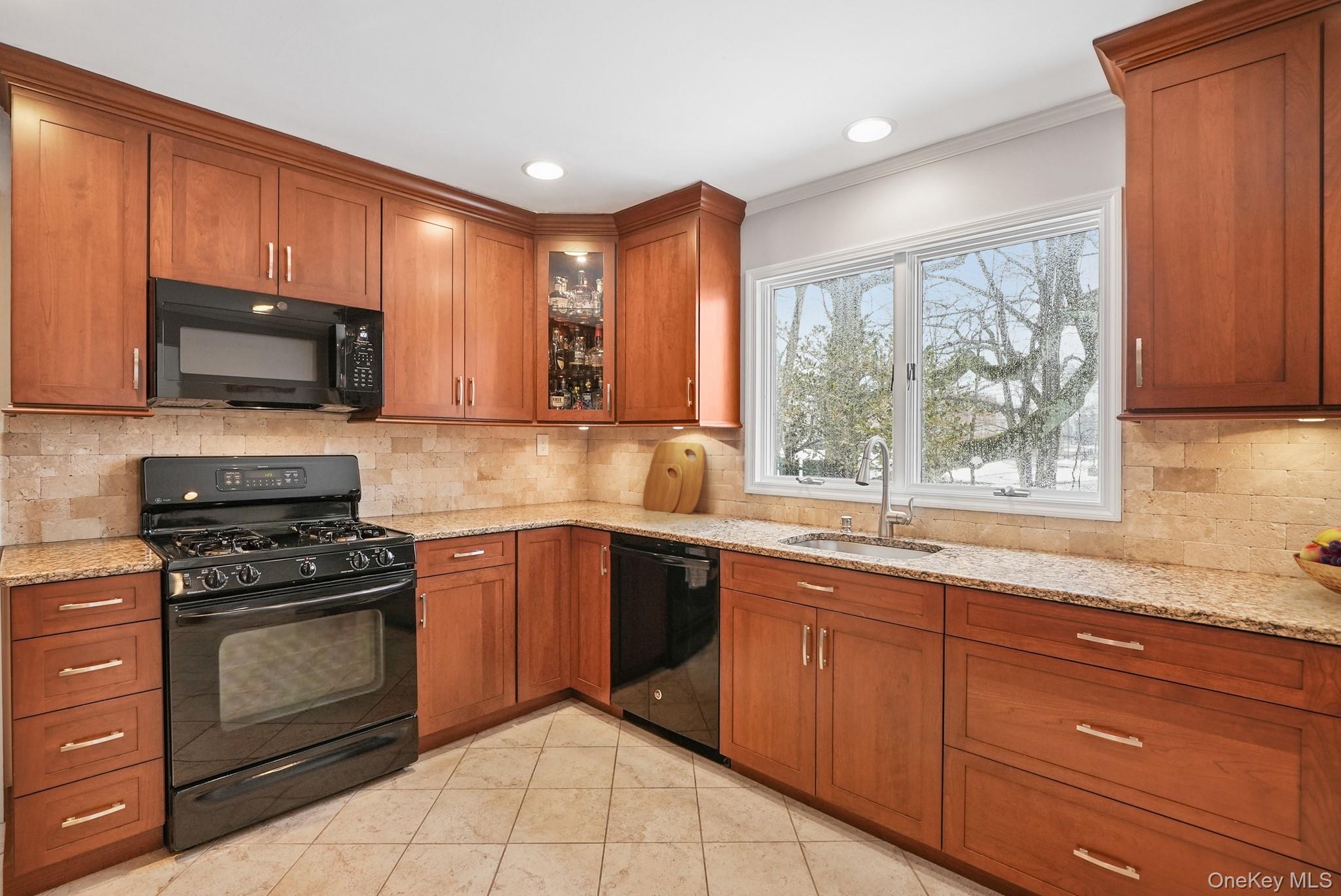 33 Overlook Road Ardsley, NY 10502 - Photo 14 of 32 a kitchen with granite countertop wooden cabinets stainless steel appliances and a window