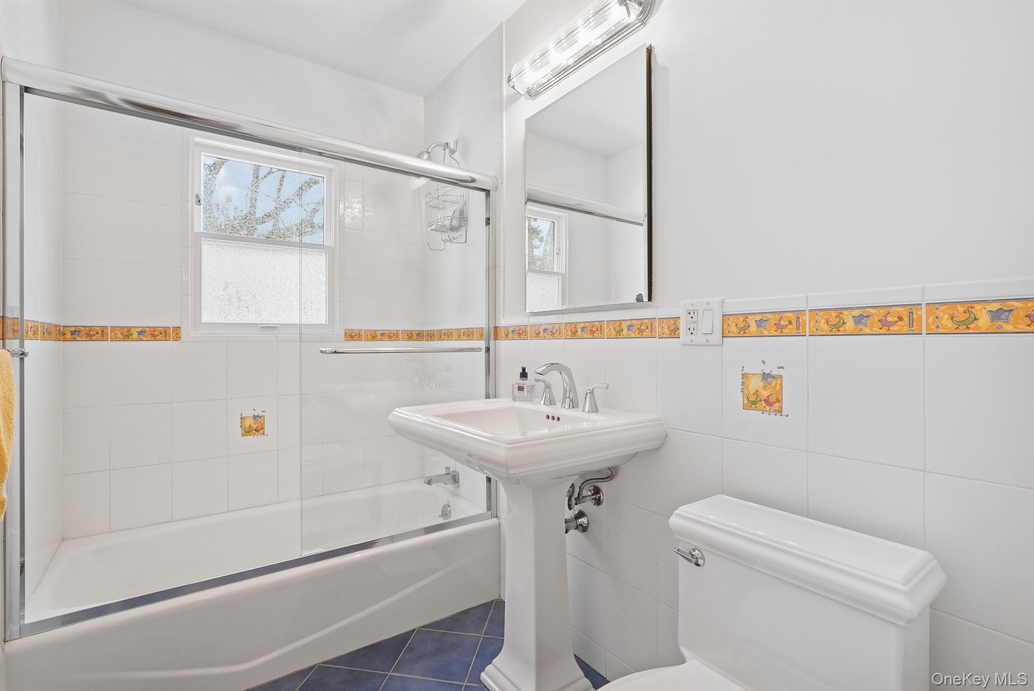 33 Overlook Road Ardsley, NY 10502 - Photo 20 of 32 a bathroom with a sink a toilet a mirror and shower