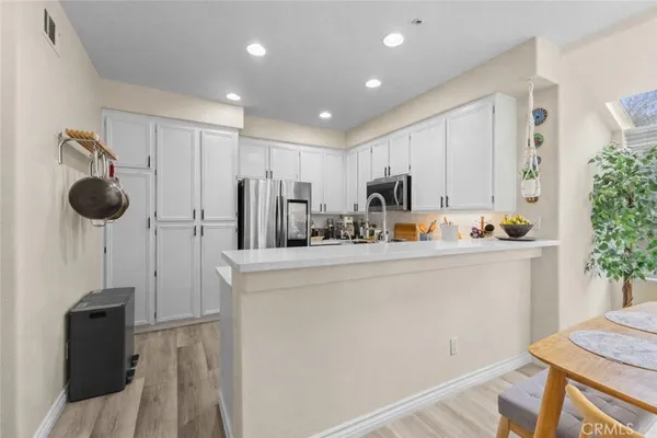 a view of kitchen with furniture and refrigerator