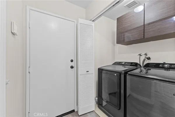 a utility room with sink dryer and washer