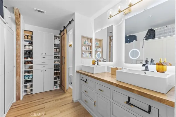 a spacious bathroom with double vanity and a shower