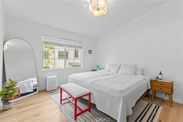 a bedroom with a bed and a chandelier