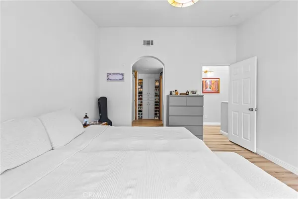 a bedroom with a bed and a couch